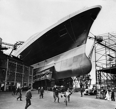 The major photography exhibition has been curated by world-renowned photographer Mary McCartney (above: ship builders playing football below the hull of the new Cunard Liner QE2 at Clyde shipyard, Scotland, 1967 -credits Mirrorpix)
